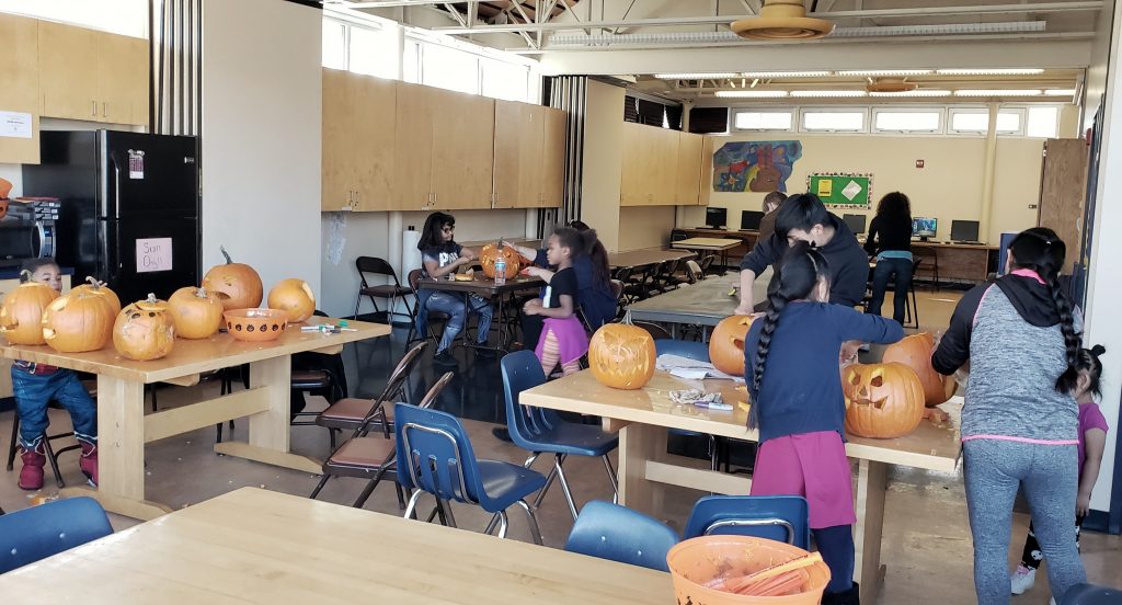 Community members carving pumpkins